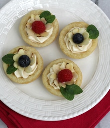 Plate with four Mini Fruit Flower Tarts.