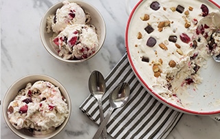 Large bowl and two serving bowls of Cherry Almond Chocolate Chunk Ice Cream.