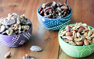 Bowls of three varieties of Spiced or Candied Nuts.