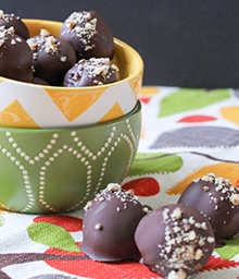 Bowl of Pecan Pie Truffles and three on counter.