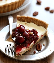 Slice of Mascarpone and Cranberry Tart with Pecan Crust.