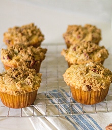 Half dozen Pecan Crumble Oatmeal Muffins on cooling rack.