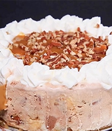 Pecan Ice Cream Cake topped with caramel and whipped cream.
