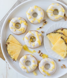 Plate of Pineapple Walnut Donuts and fresh pineapple.