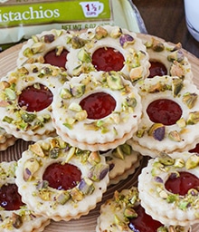 Pile of Pistachio Wreath Cookies with cranberry topping in center.