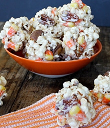 Overflowing bowl of Halloween Popcorn Balls.