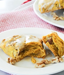 Pumpkin Walnut Scone with Maple Glaze with bite taken out.