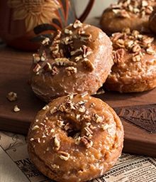 Pumpkin Spice Donuts with Maple Glaze and chopped pecans.