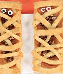 Two Pumpkin Pecan Mummies with googly eyes.