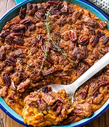 Spoon digging into Simple Sweet Potato Casserole with Crunchy Pecan Crumble.