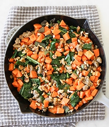 Cast iron of Sweet Potatoes with Sausage, Kale and Walnuts.