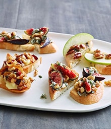 Several crostinis with three different toppings on a plate.