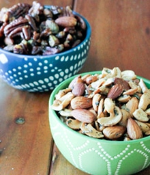 Two bowls of different spiced nuts.