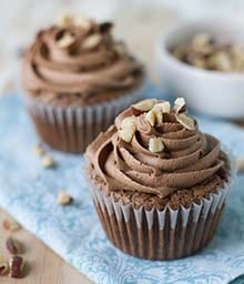 Hazelnut Brownie Cupcakes with frosting and chopped Diamond nuts.