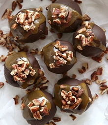 Turtle Cookie Truffles topped with chopped nuts.