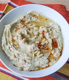Bowl of Walnut Hummus with Toasted Pine Nuts.