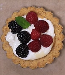 Top view Walnut Yogurt Tart with raspberries and blackberries.