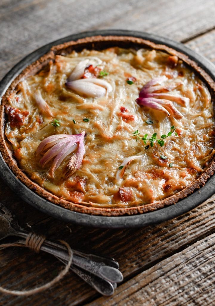 Cast iron dish of Caramelized Onion Tart with Walnut Pie Crust.